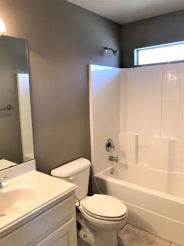 a bathroom with a toilet a sink and bathtub