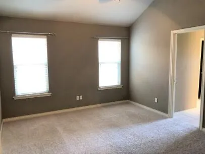 an empty room with windows and closet