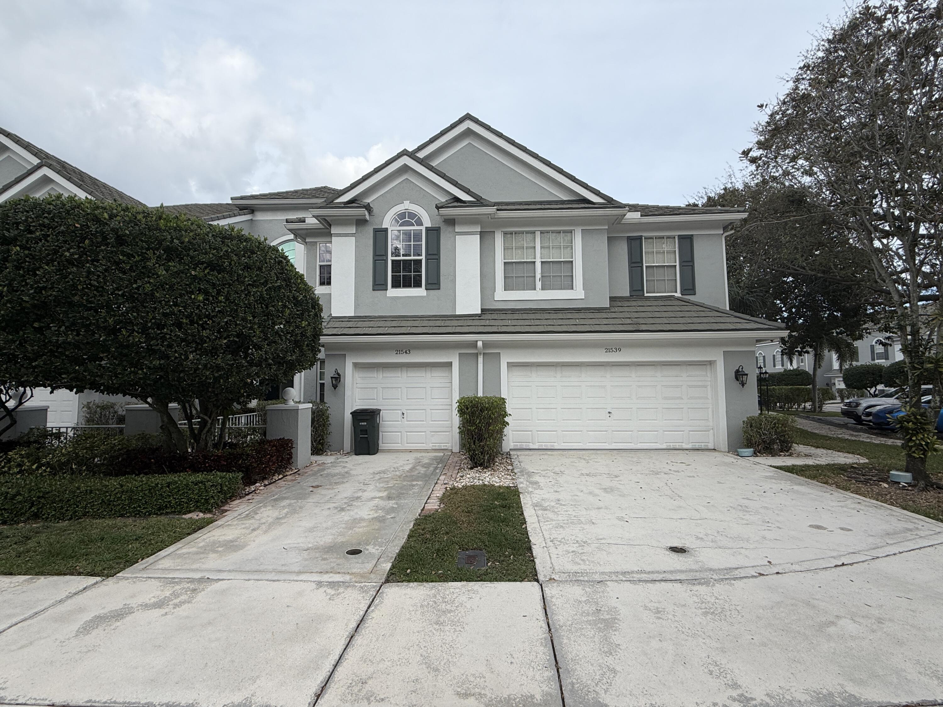 21543 St Andrews Grand Circle, Unit 41 Boca Raton, FL 33486 - Photo 1 of 27 a view of a white house with a large space