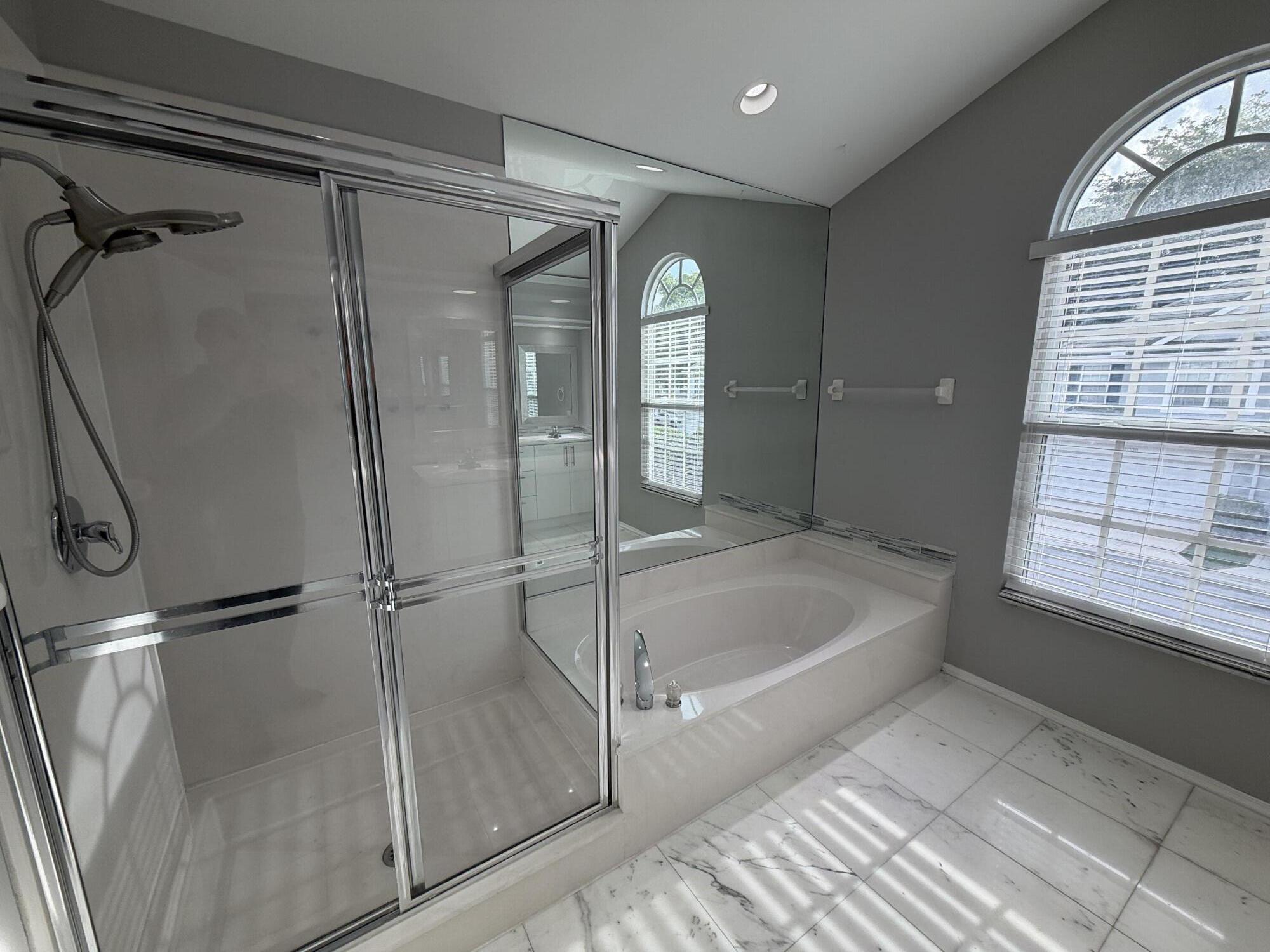 21543 St Andrews Grand Circle, Unit 41 Boca Raton, FL 33486 - Photo 17 of 27 a spacious bathroom with a bathtub and a shower