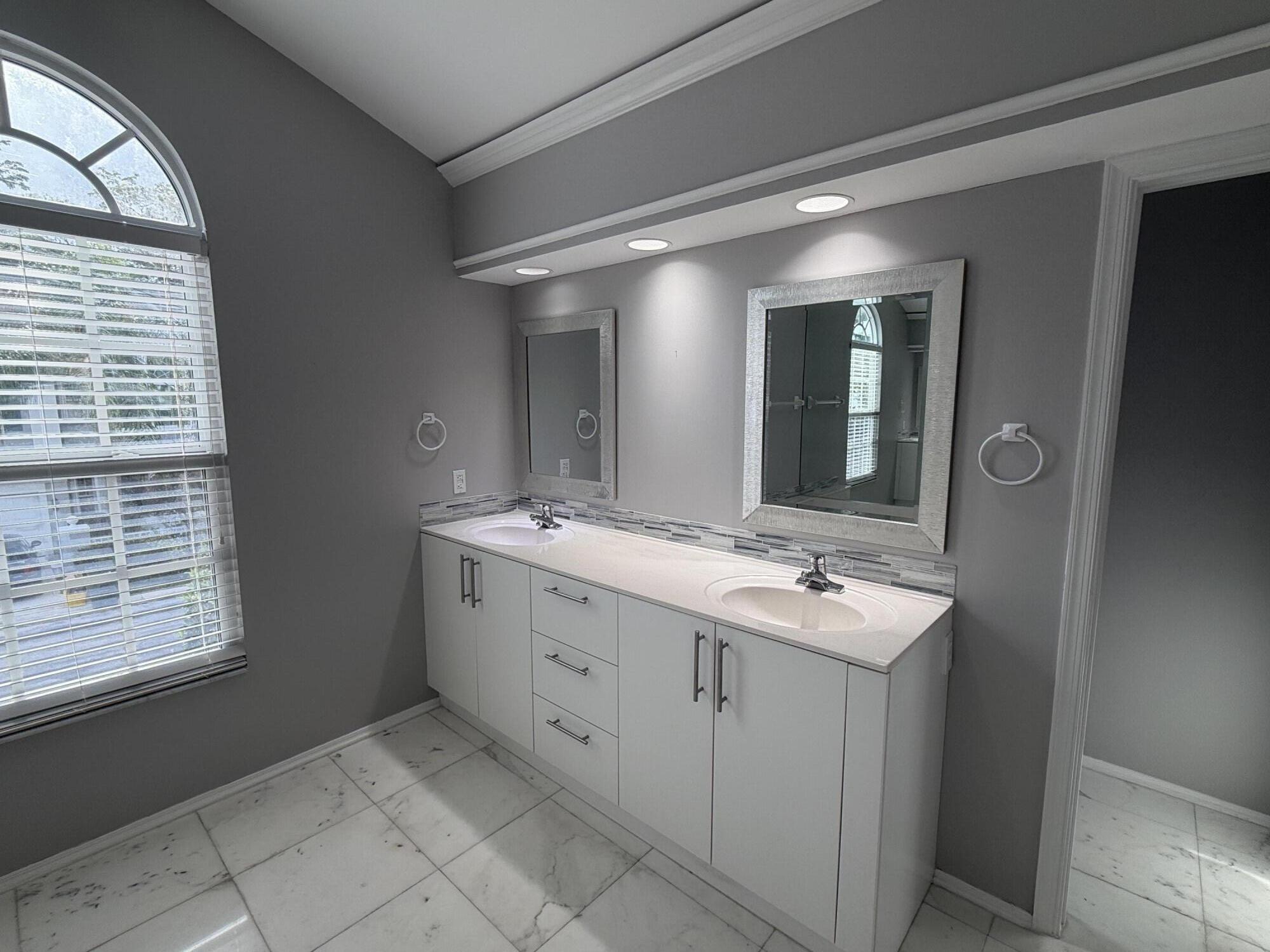 21543 St Andrews Grand Circle, Unit 41 Boca Raton, FL 33486 - Photo 18 of 27 a bathroom with a sink and a mirror