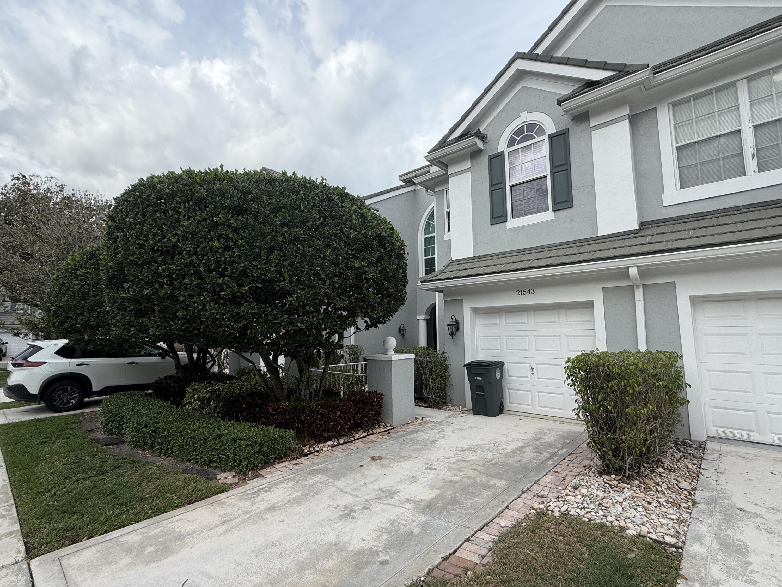 21543 St Andrews Grand Circle, Unit 41 Boca Raton, FL 33486 - Photo 2 of 27 a view of a house with a yard and plants