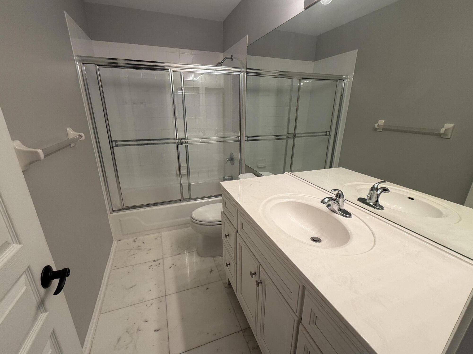 21543 St Andrews Grand Circle, Unit 41 Boca Raton, FL 33486 - Photo 21 of 27 a bathroom with a sink and mirror