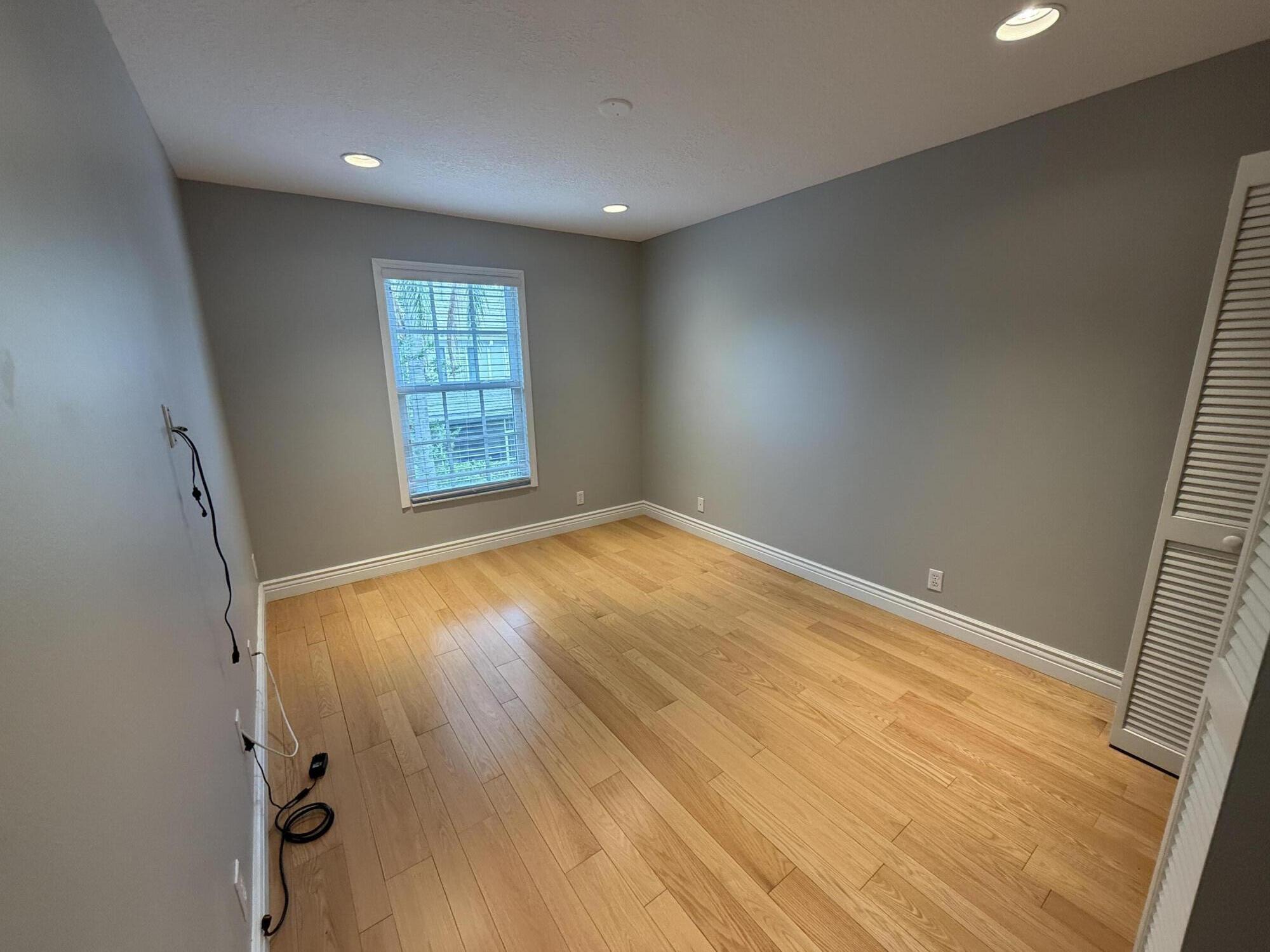21543 St Andrews Grand Circle, Unit 41 Boca Raton, FL 33486 - Photo 22 of 27 wooden floor in an empty room with a window