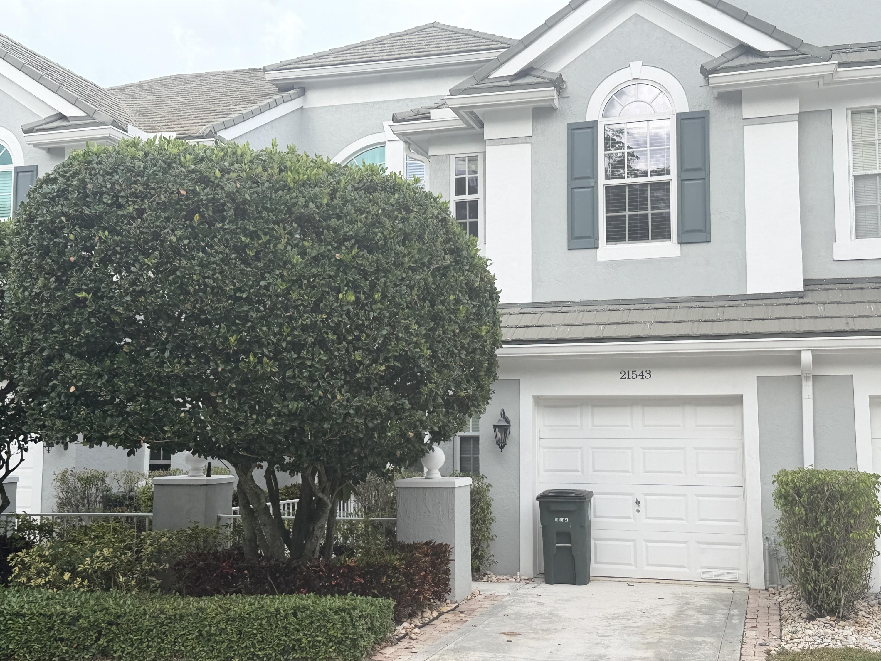 21543 St Andrews Grand Circle, Unit 41 Boca Raton, FL 33486 - Photo 26 of 27 a front view of a house with a garden