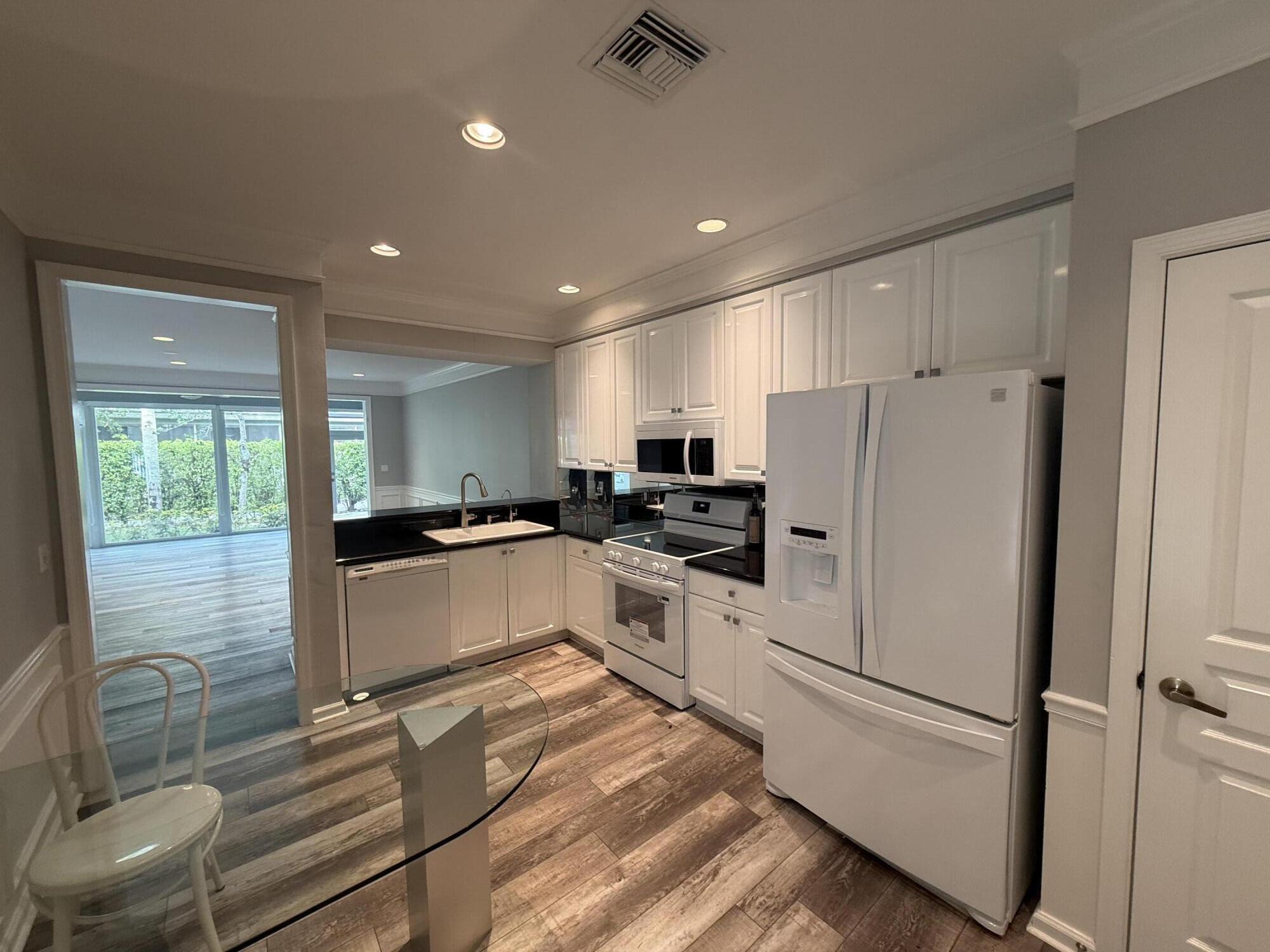 21543 St Andrews Grand Circle, Unit 41 Boca Raton, FL 33486 - Photo 3 of 27 a kitchen with a refrigerator a sink and cabinets