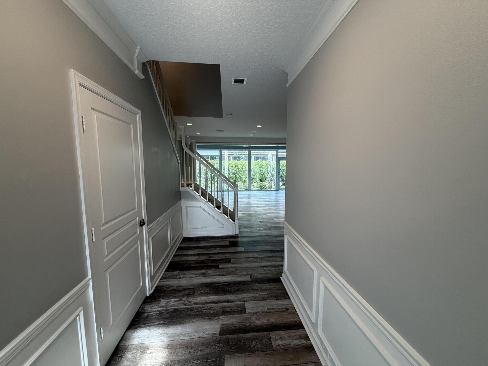 21543 St Andrews Grand Circle, Unit 41 Boca Raton, FL 33486 - Photo 6 of 27 a view of a hallway with wooden floor and entryway