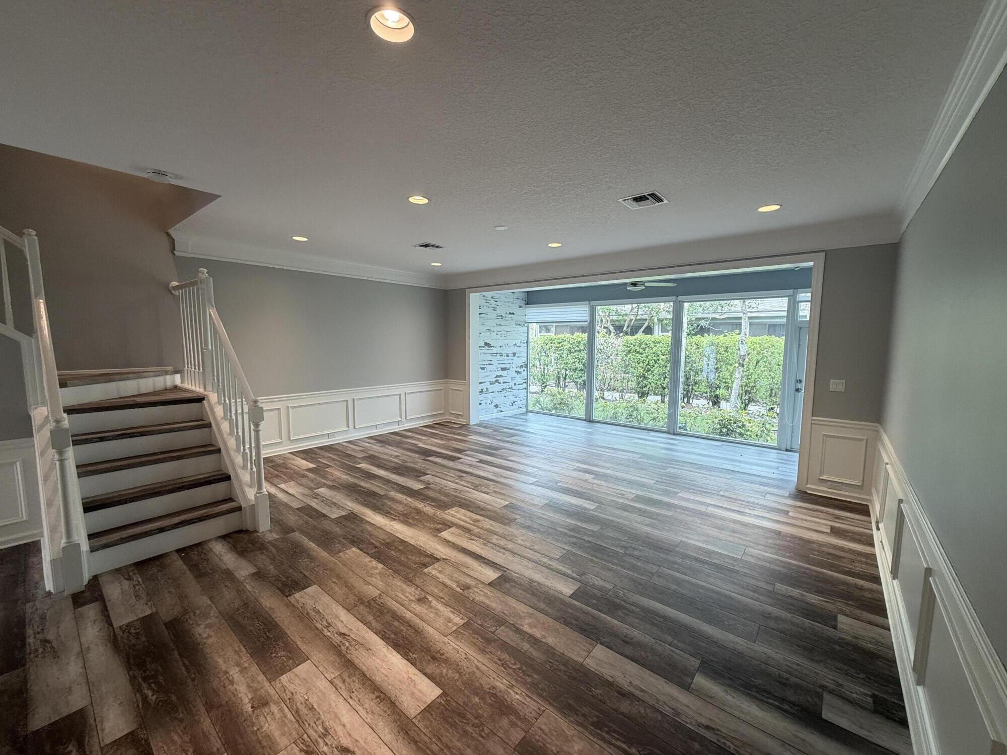 21543 St Andrews Grand Circle, Unit 41 Boca Raton, FL 33486 - Photo 8 of 27 a view of wooden floor and windows in a room