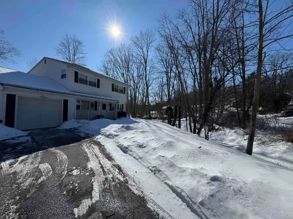 a view of house with snow on the road