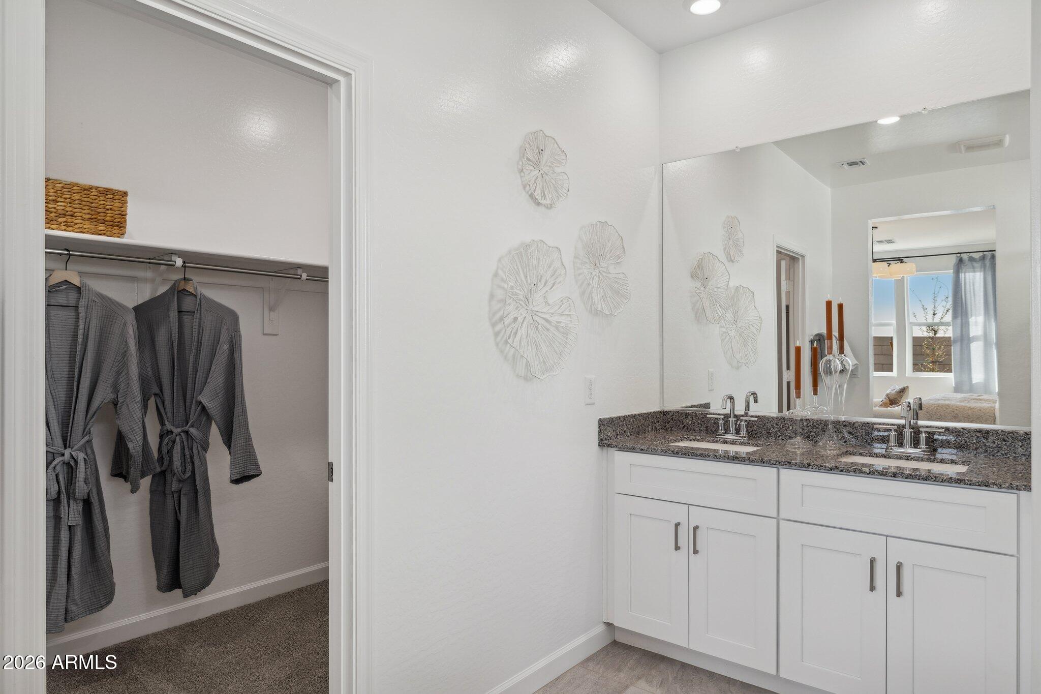 26449 West Crown King Road Buckeye, AZ 85326 - Photo 20 of 33 a bathroom with a granite countertop sink a mirror and shower