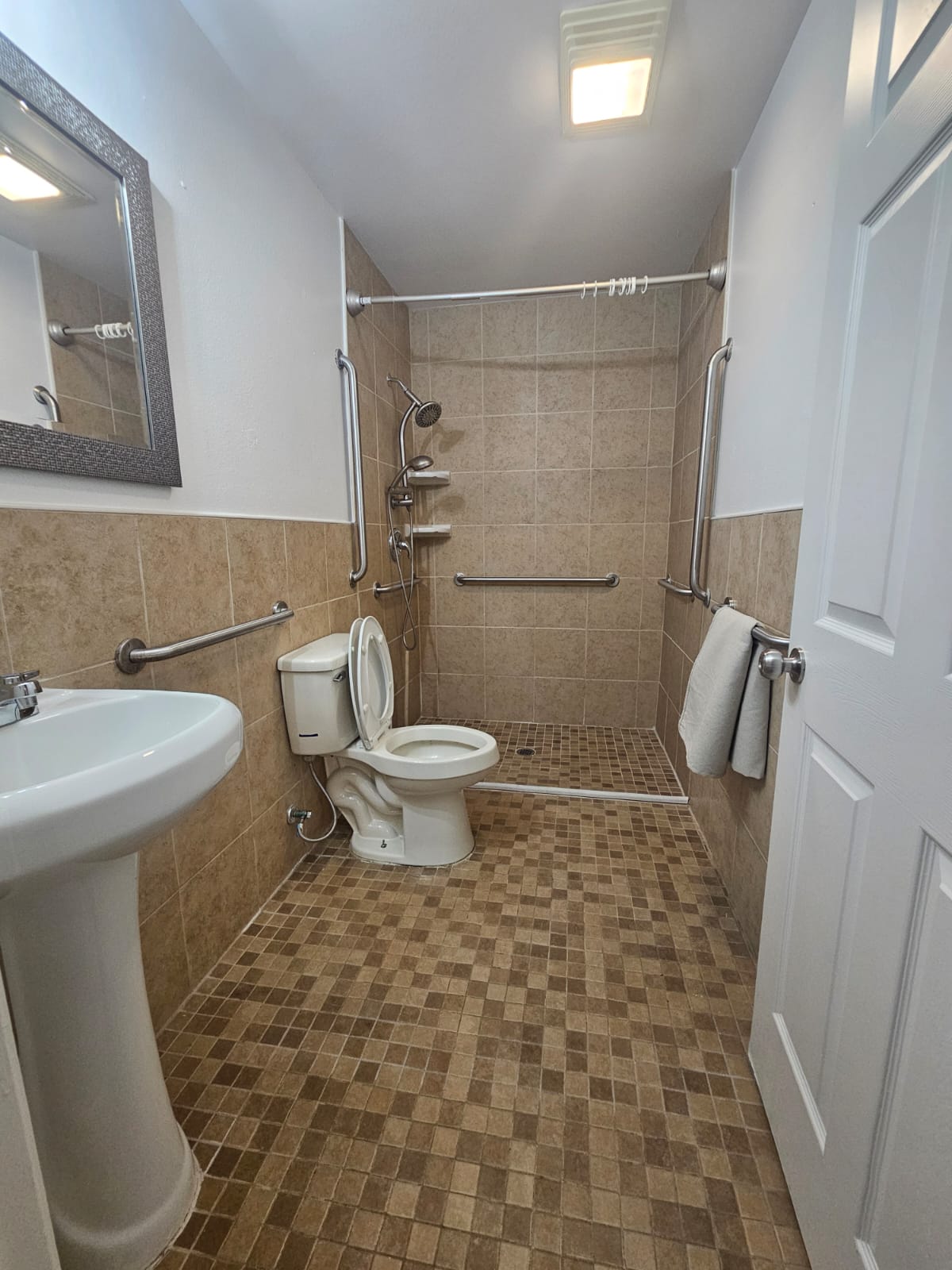 606 Trinity Street Lockhart, TX 78644 - Photo 11 of 23 A well-appointed bathroom with a convenient walk-in shower and tasteful tile finishes.