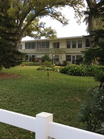 a view of house with a yard