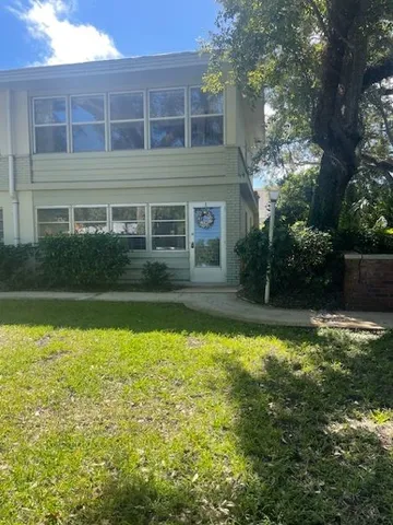 a backyard of a house with table and chairs