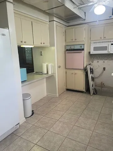 a view of a hallway and closet with a mirror