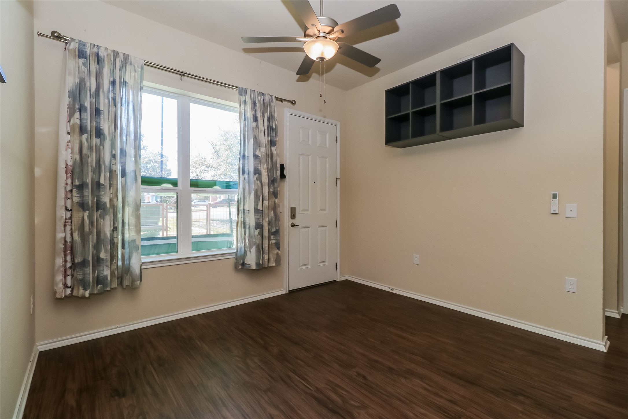 8601 West Gate Boulevard, Unit 7101 Austin, TX 78745 - Photo 5 of 16 Entryway with ceiling fan and dark wood finished floors