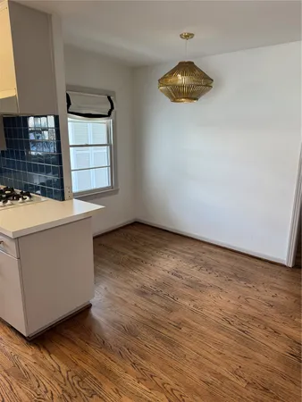 a room with a wooden floor and a chandelier