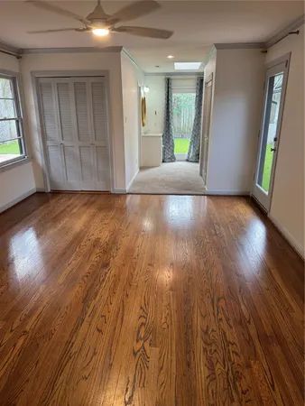 wooden floor in an empty room with a window