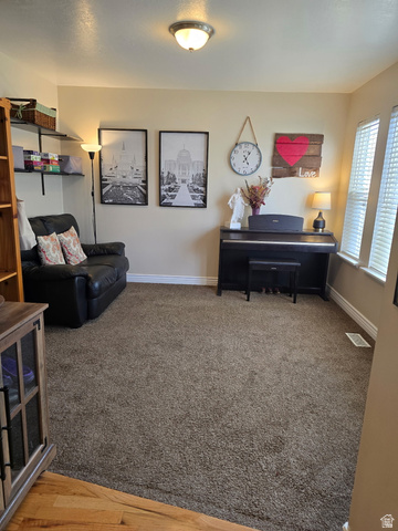 7532 North Castle Rock Road Eagle Mountain, UT 84005 - Photo 15 of 40 Main Floor Sitting room with baseboards and dark carpet