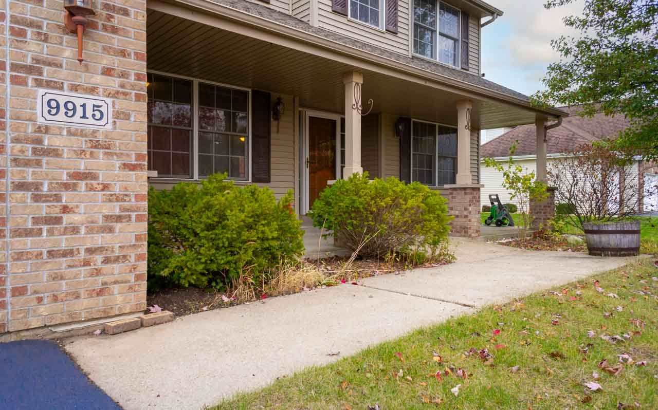 9915 Rambouillet Ridge Roscoe, IL 61073 - Photo 3 of 35 front view of a brick house with potted plants