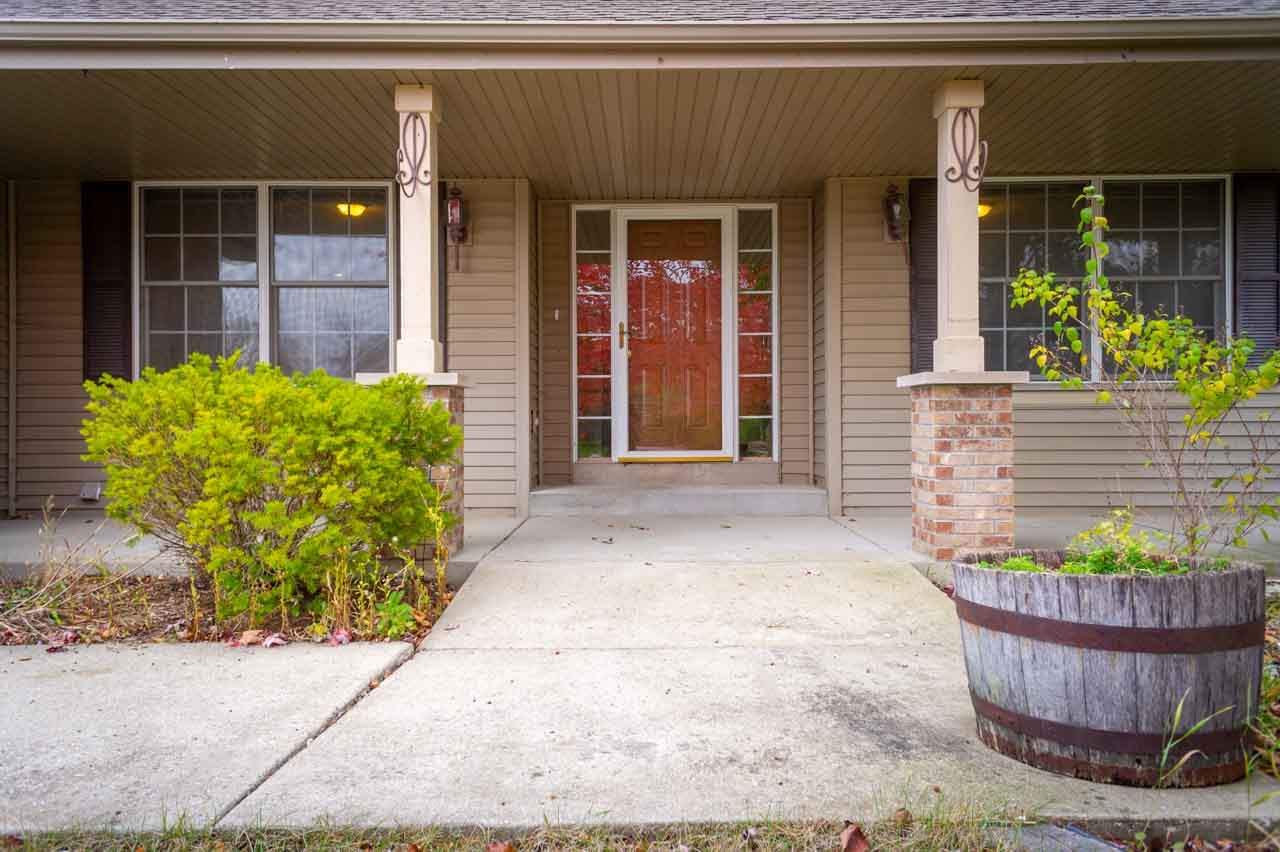 9915 Rambouillet Ridge Roscoe, IL 61073 - Photo 4 of 35 a view of a house with potted plants and a bench