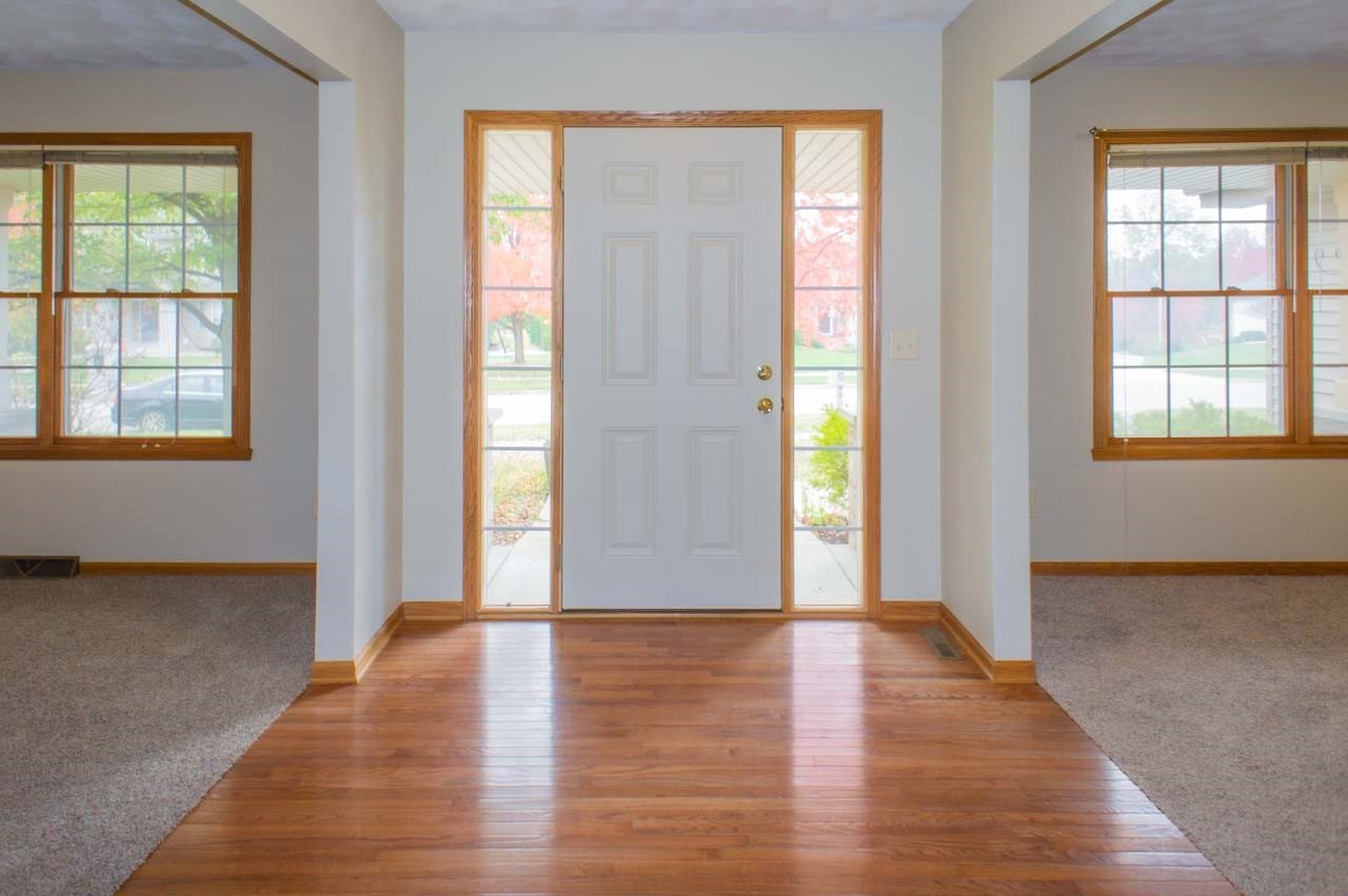 9915 Rambouillet Ridge Roscoe, IL 61073 - Photo 5 of 35 a view of an empty room with wooden floor and a window