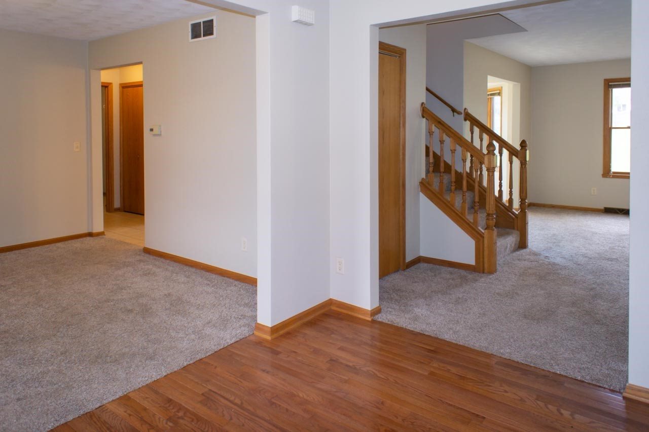 9915 Rambouillet Ridge Roscoe, IL 61073 - Photo 6 of 35 a view of an empty room with wooden floor and stairs