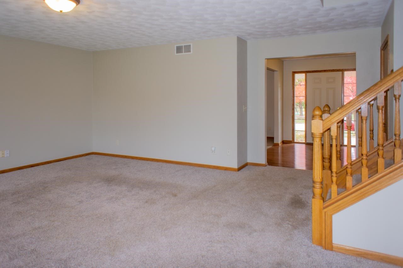 9915 Rambouillet Ridge Roscoe, IL 61073 - Photo 8 of 35 an empty room with wooden floor and windows