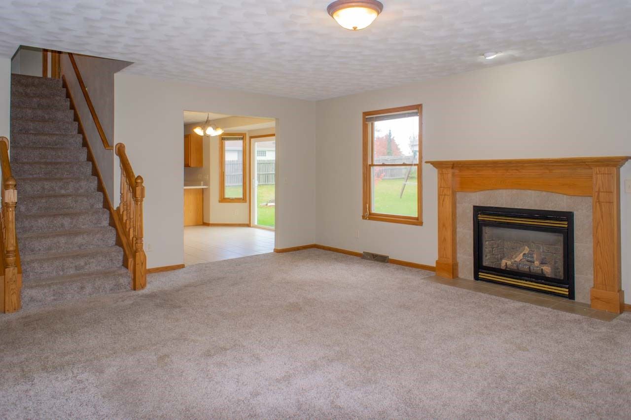 9915 Rambouillet Ridge Roscoe, IL 61073 - Photo 9 of 35 an empty room with windows and fireplace
