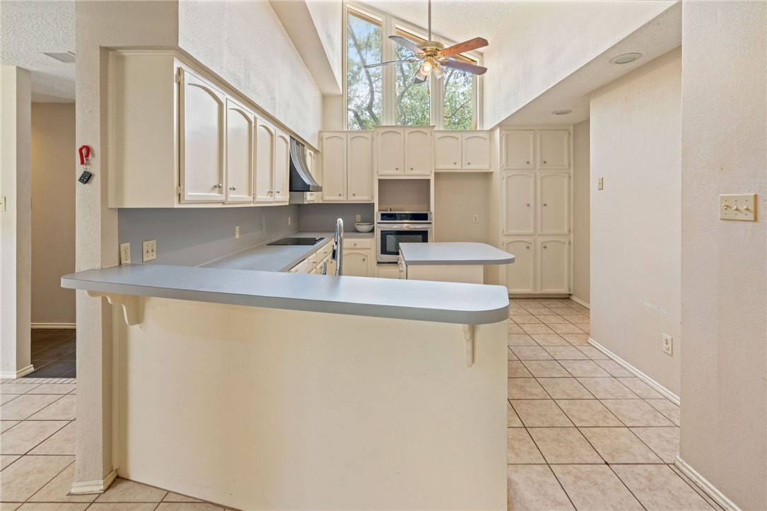 7209 Candy Ridge Road Corpus Christi, TX 78413 - Photo 8 of 24 a kitchen with stainless steel appliances a sink a stove a refrigerator a counter top space and cabinets