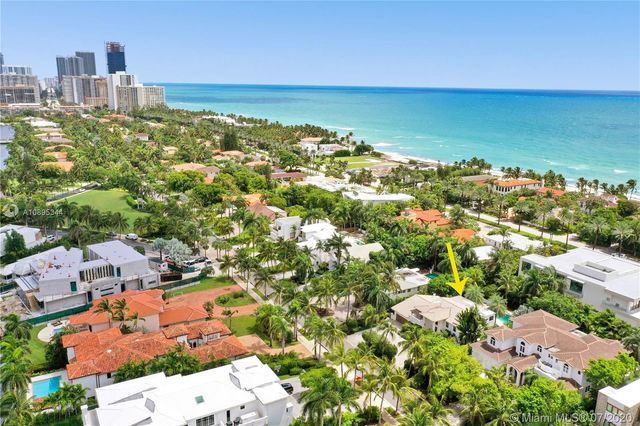a view of a house with backyard porch and sitting area