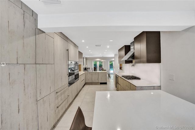 a bathroom with a double vanity sink mirror and shower