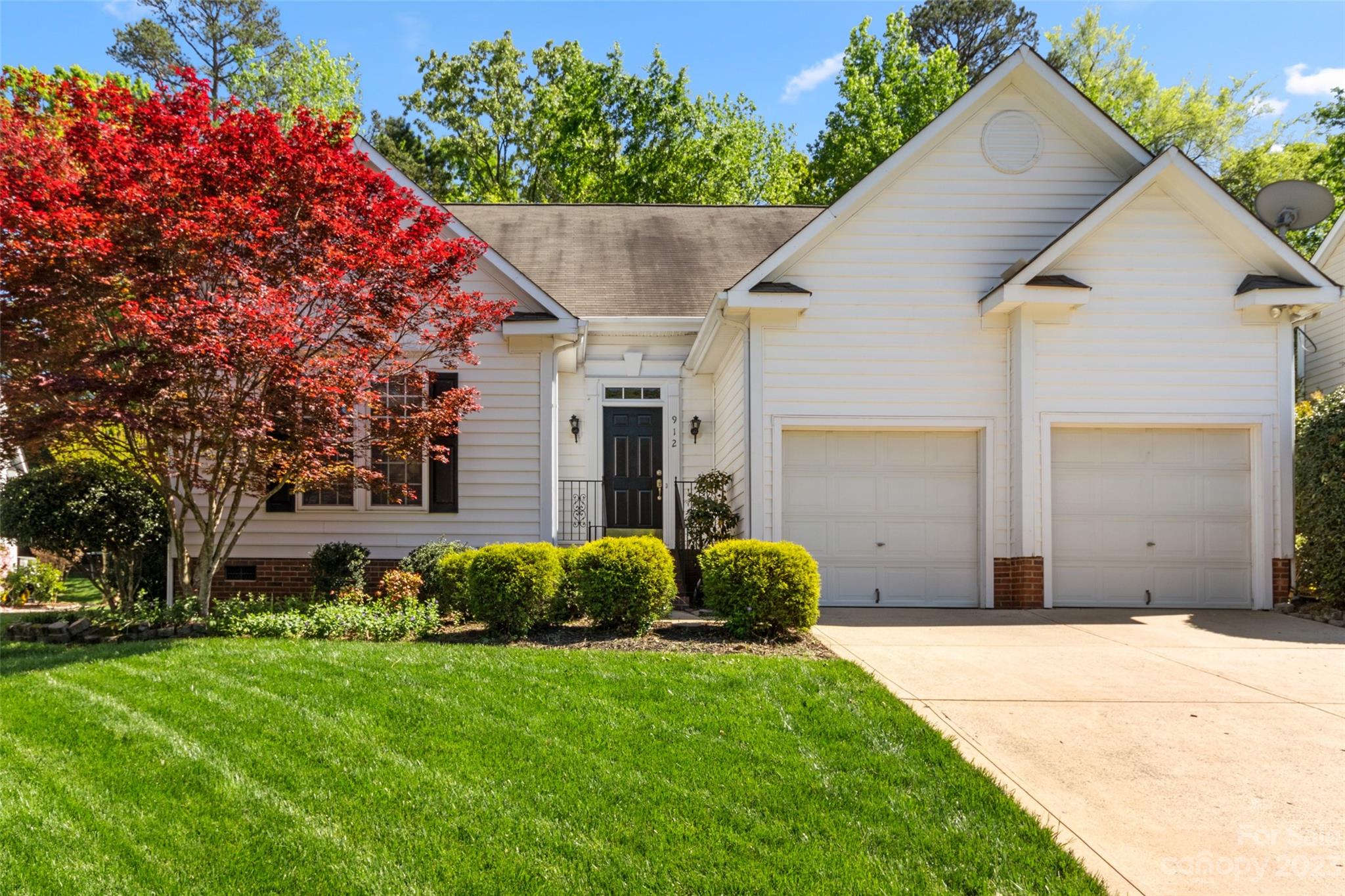 912 Cadogan Court Fort Mill, SC 29708 - Photo 2 of 26 a view of a house with a small yard plants and a large tree