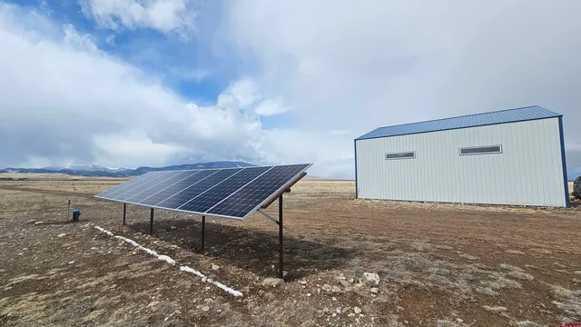 a wooden bench sitting in middle of a field