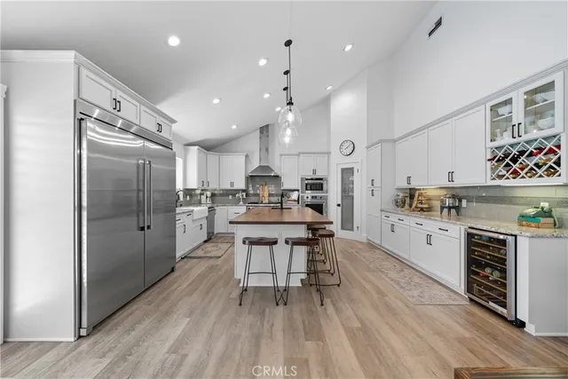 a kitchen with stainless steel appliances granite countertop a lot of counter space and wooden floor