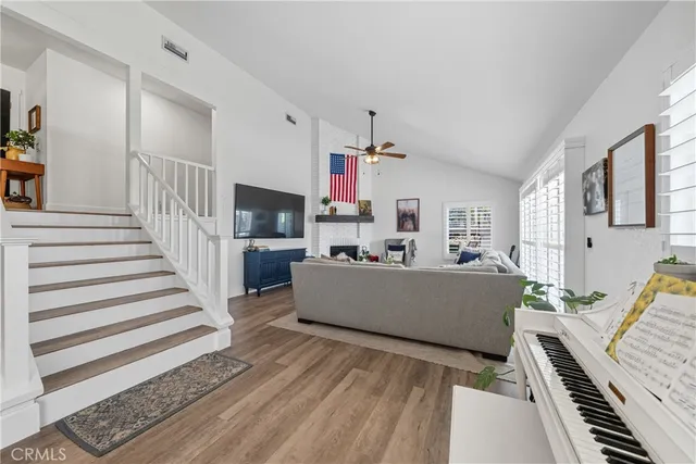 a living room with furniture a flat screen tv and a fireplace