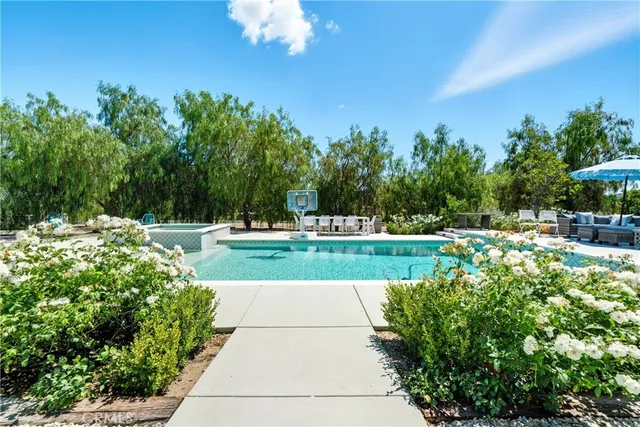 a view of a house with a backyard and garden