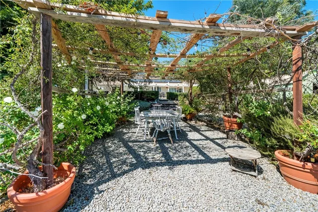 a view of a house with a backyard and a patio