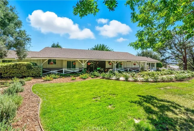 a front view of house with yard and green space