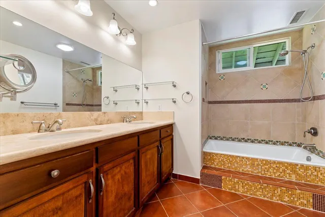 a spacious bathroom with a double vanity sink a mirror and a bathtub