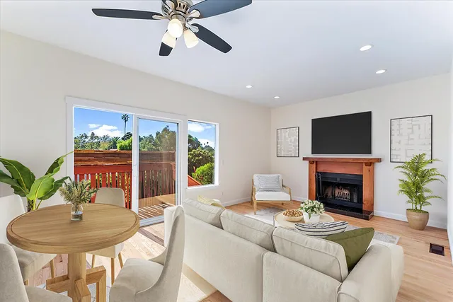 a living room with furniture a fireplace and a flat screen tv