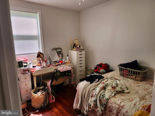 a bedroom with two beds and a dresser