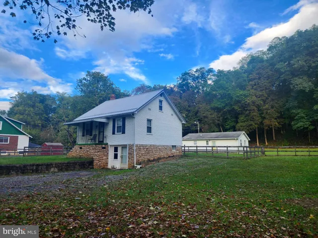 a house view with a sitting space and garden