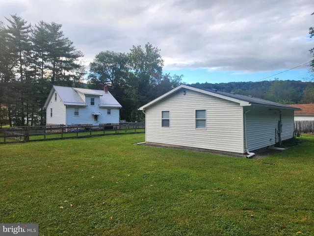 a view of a backyard with large trees