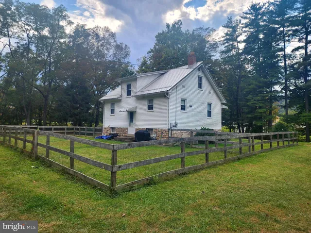 a front view of house with yard and outdoor seating