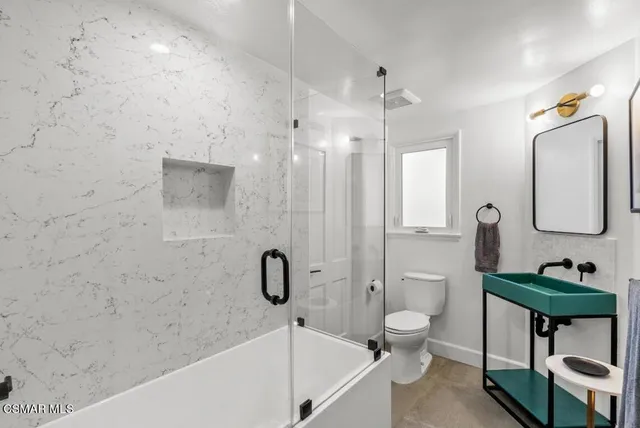 a bathroom with a toilet a sink and bathtub