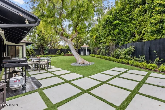 a view of a backyard with sitting area