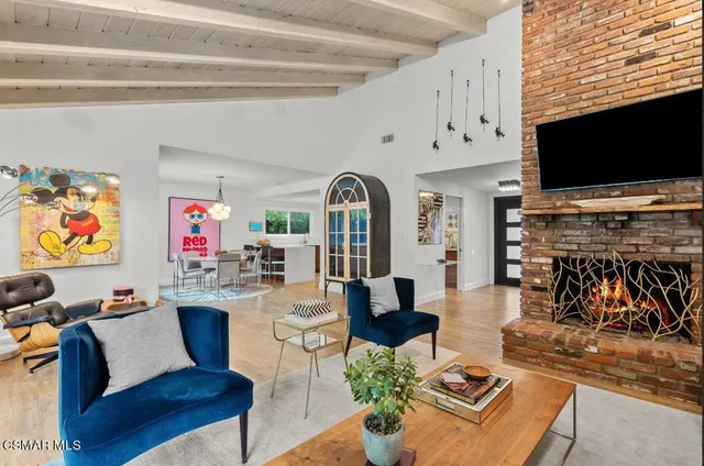 a living room with fireplace furniture and a flat screen tv