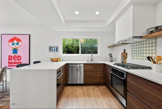 a kitchen with a sink stove and cabinets