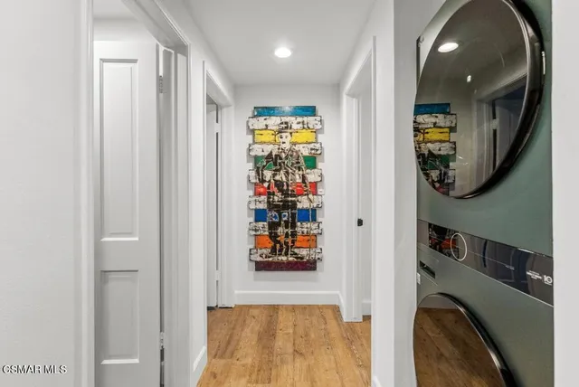 a view of a hallway with wooden floor and windows