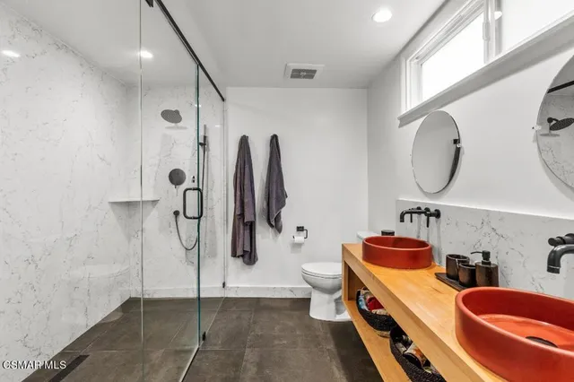 a bathroom with a tub sink and mirror